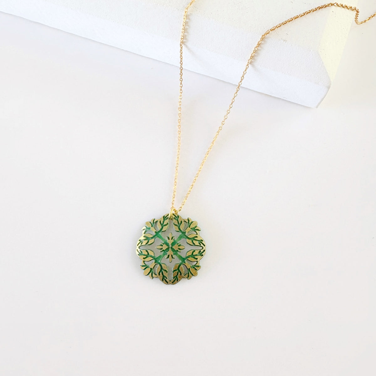 Leighton Lam Designs Pikake Patina Holiday Set with jewelry pieces featuring floral and patina details on a white background