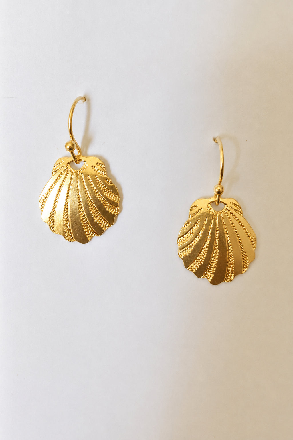 Leighton Lam Designs Sunrise Shell Earrings featuring natural shell pendants and silver hooks on a white background.