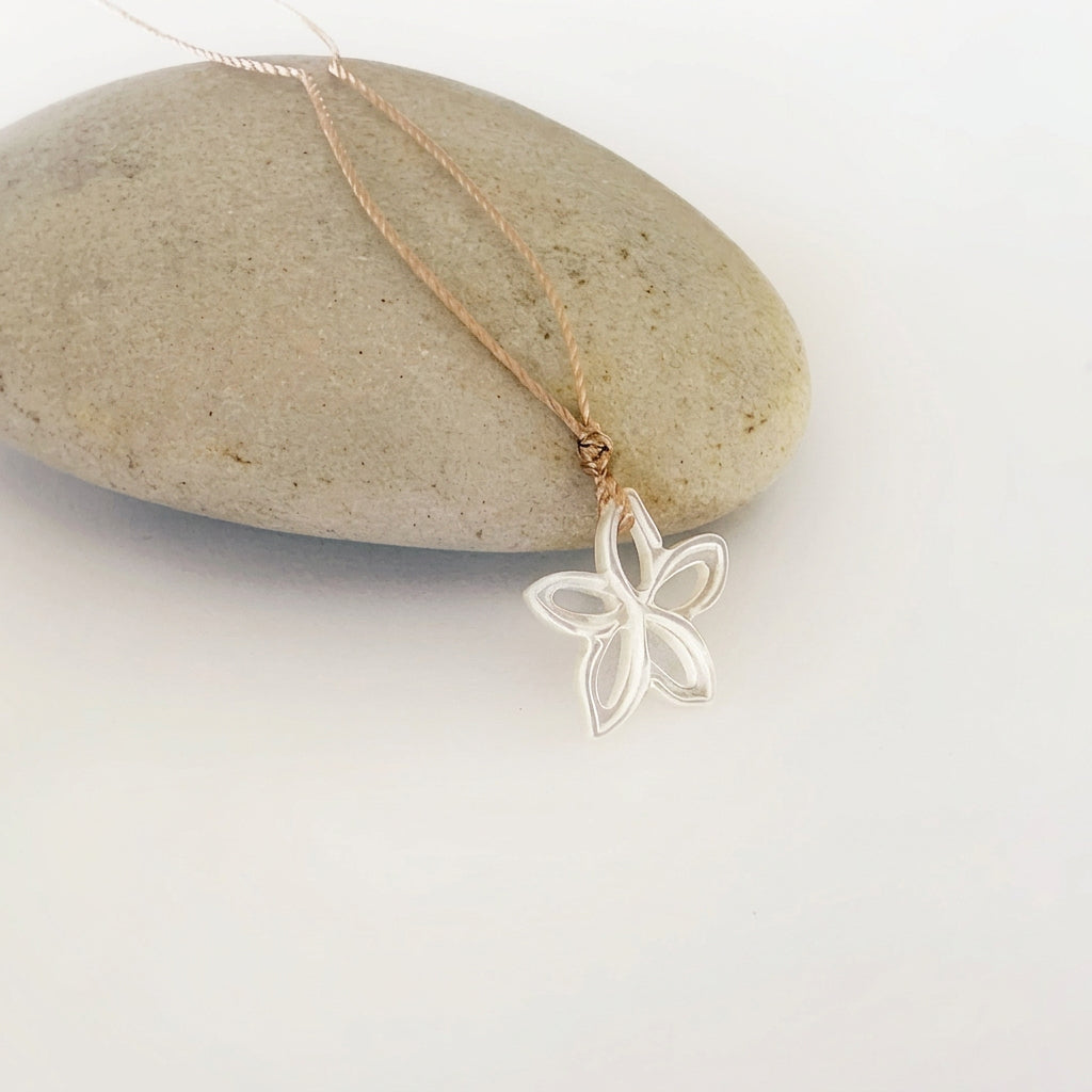 Leighton Lam Designs carved dancing Plumeria earrings featuring detailed floral jewelry in a natural finish.