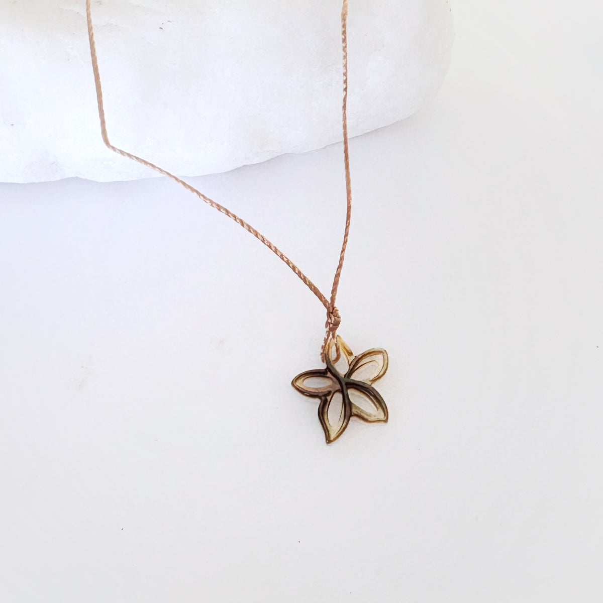 Leighton Lam Designs carved dancing plumeria earrings featuring intricate flower motifs, handcrafted jewelry for elegant style.
