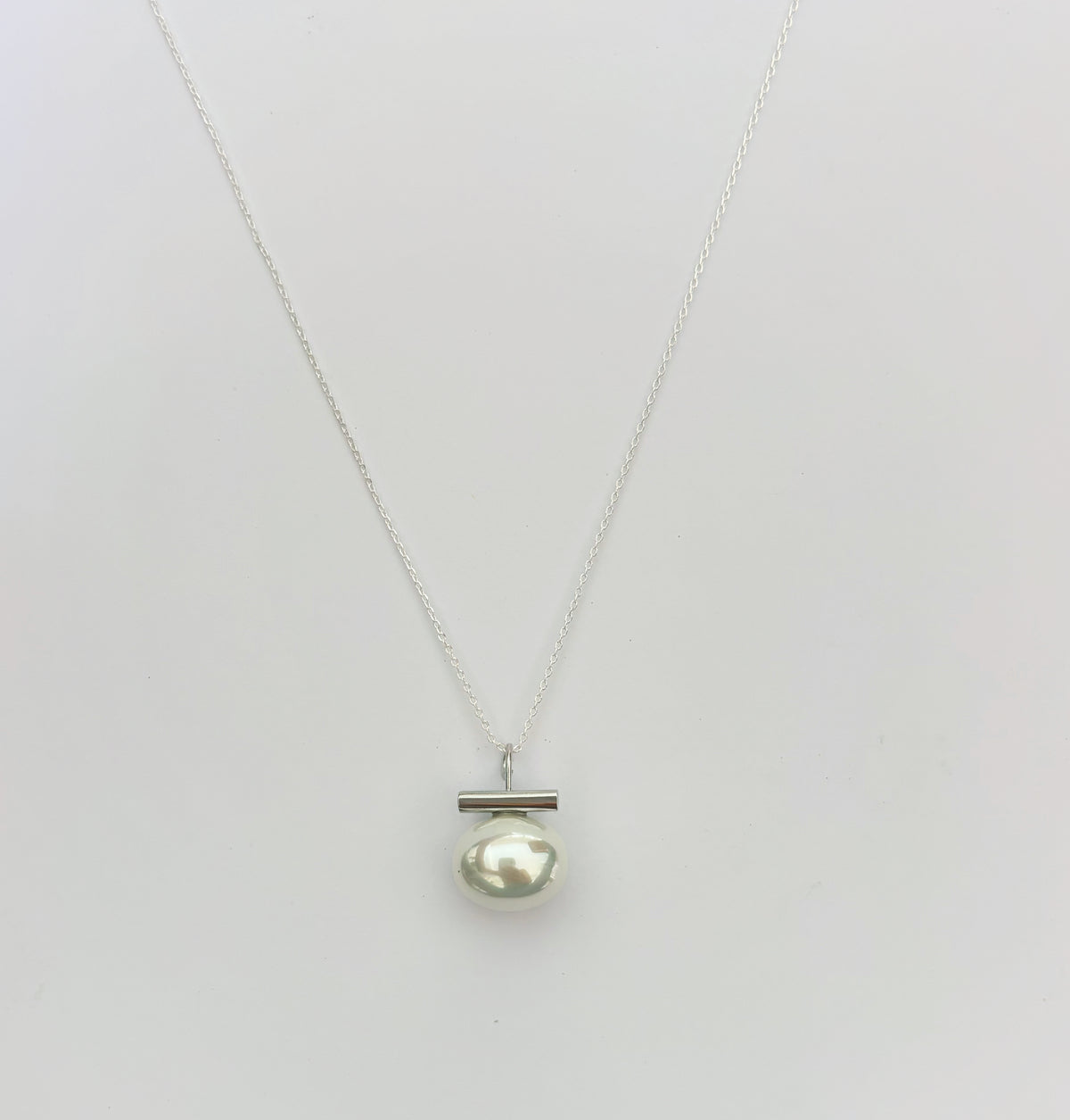 Leighton Lam Designs Ohelo Pearl Necklace featuring elegant white pearls and a delicate chain on a neutral background.