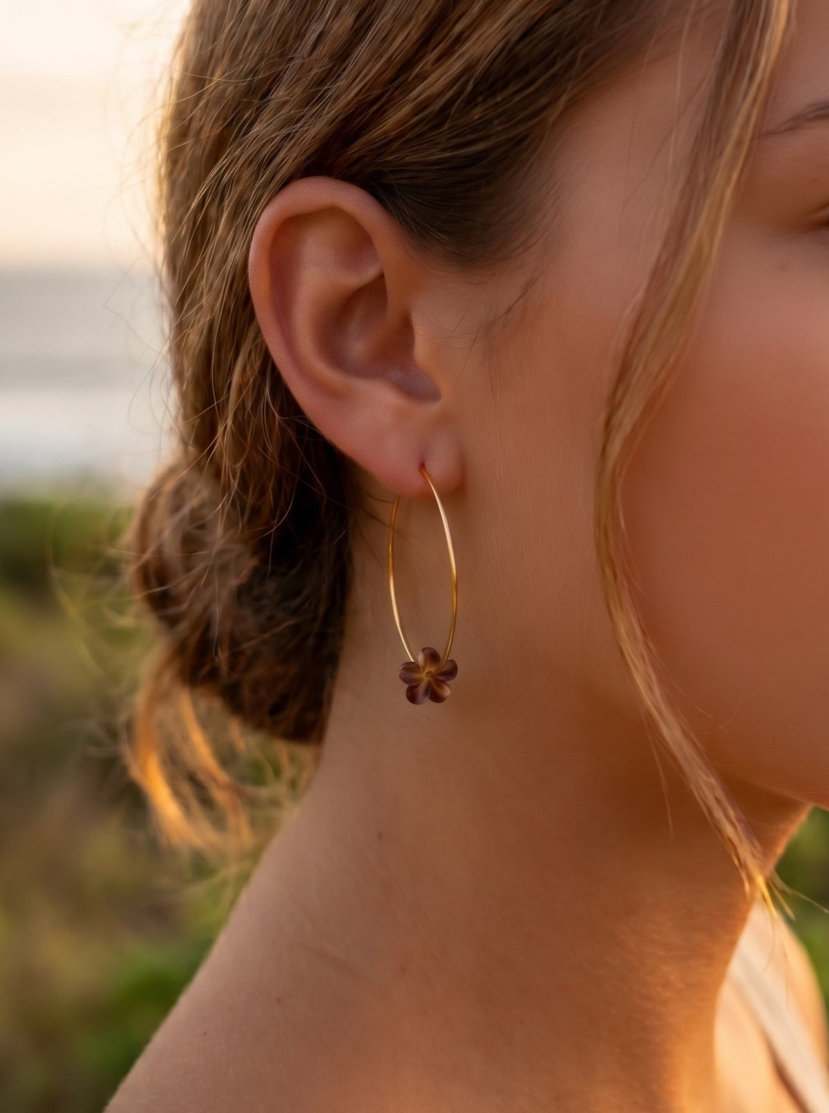 plumeria carved shell gold hoop on model