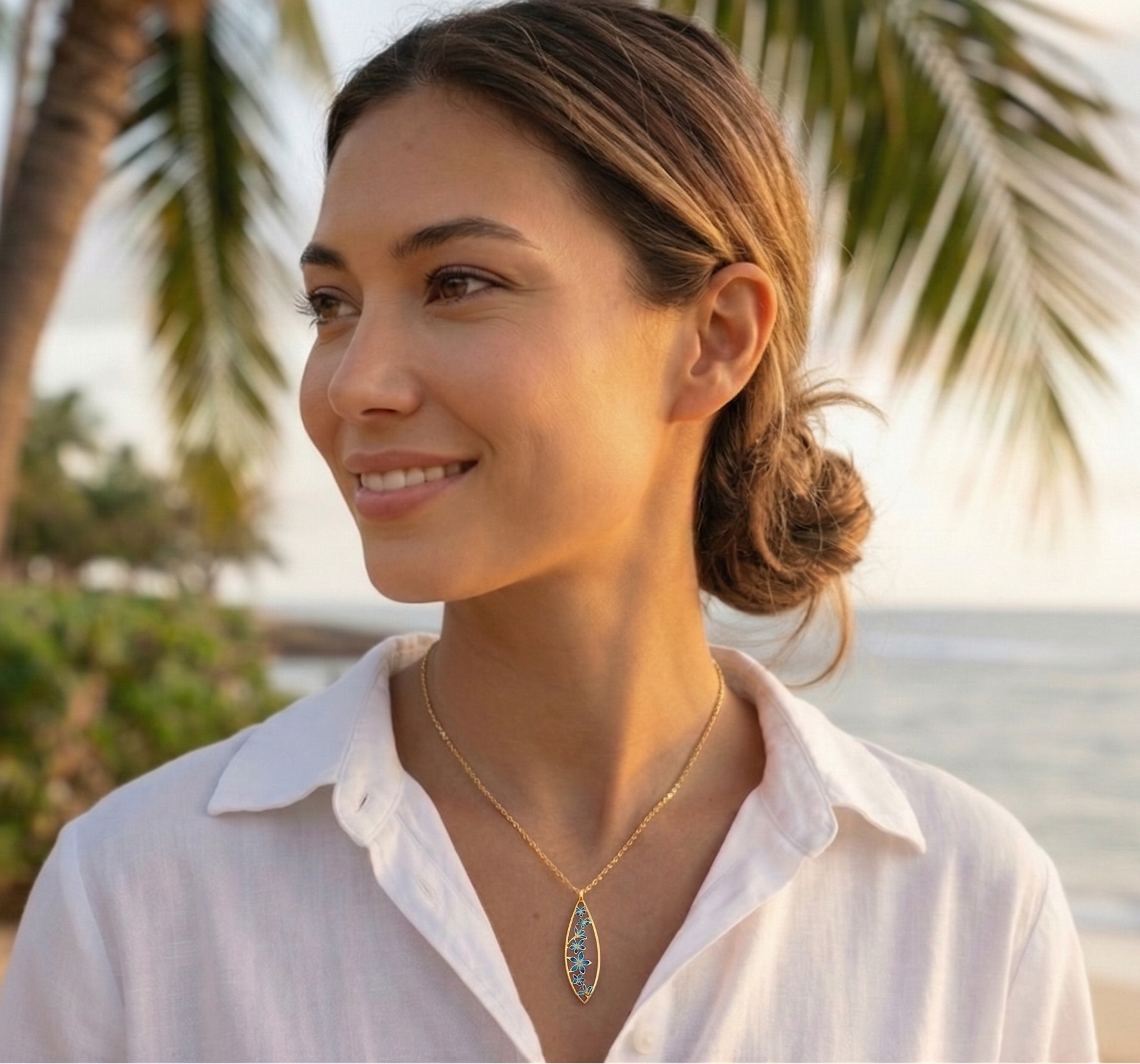 Woman on a beach with a plumeria teardrop flower necklace