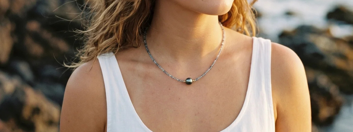 Woman wearing a Tahitian pearl necklace with sea beads. In Hawaii
